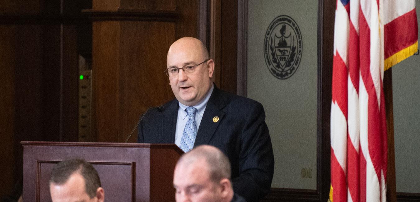 Representative Sanchez speaking at podium at hearing